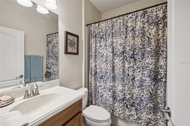 bathroom featuring vanity, toilet, and a textured ceiling