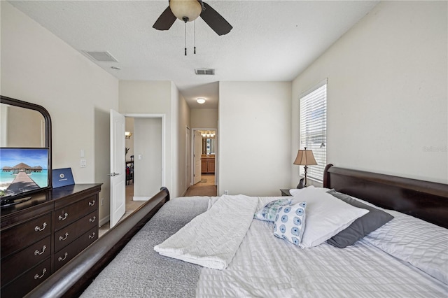 bedroom with ceiling fan, ensuite bath, and dark hardwood / wood-style flooring