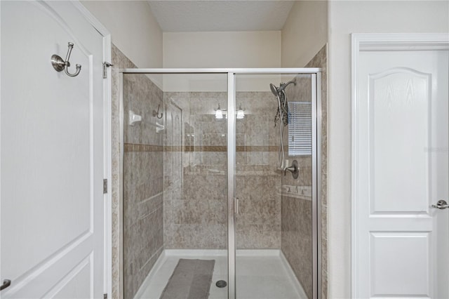 bathroom with a shower with door