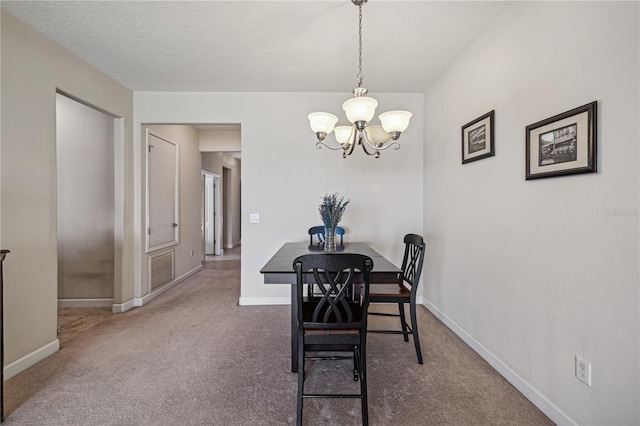 carpeted dining area featuring a notable chandelier