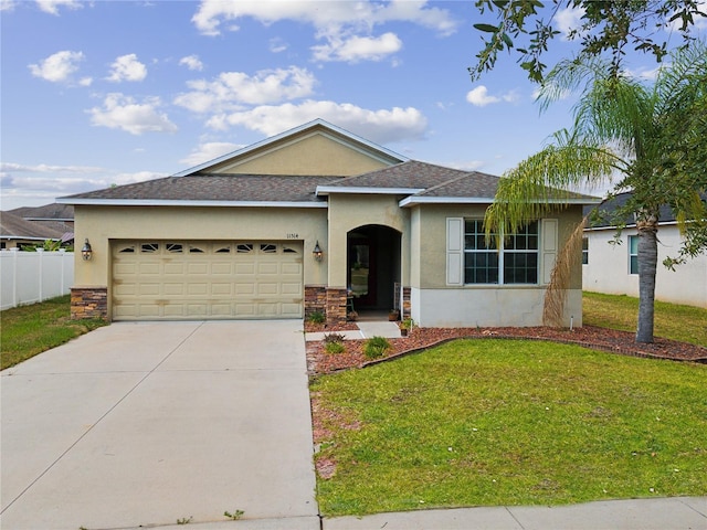 ranch-style home featuring a garage and a front yard