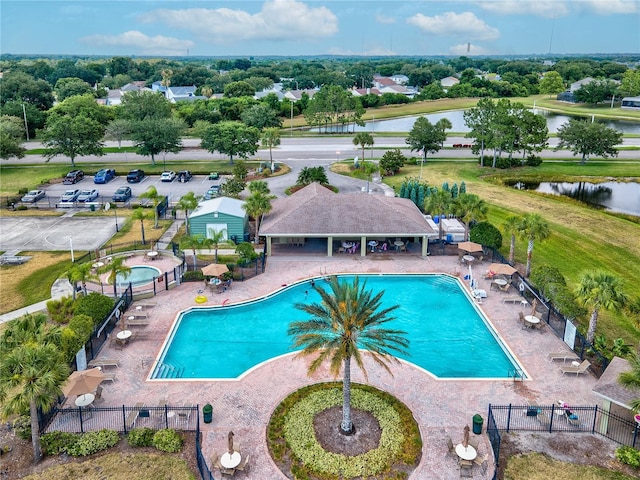 view of swimming pool with a patio and a water view