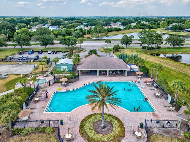 view of swimming pool with a patio area and a water view