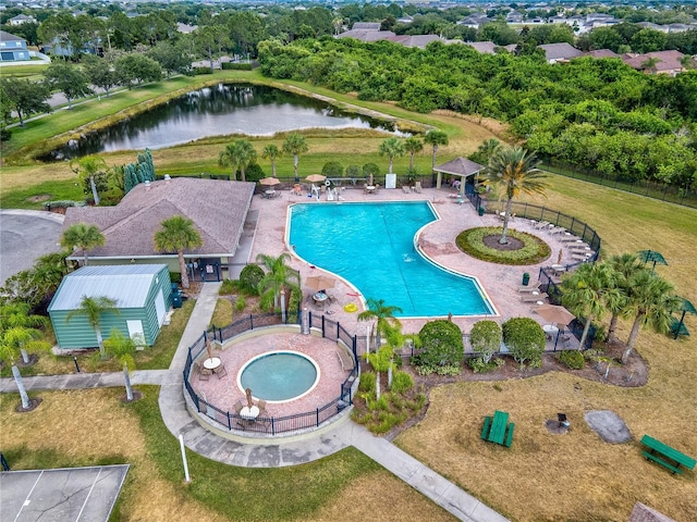 view of swimming pool with a patio, a water view, a hot tub, and an outdoor structure