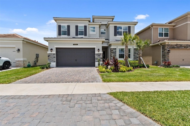 view of front of property with a garage and a front yard