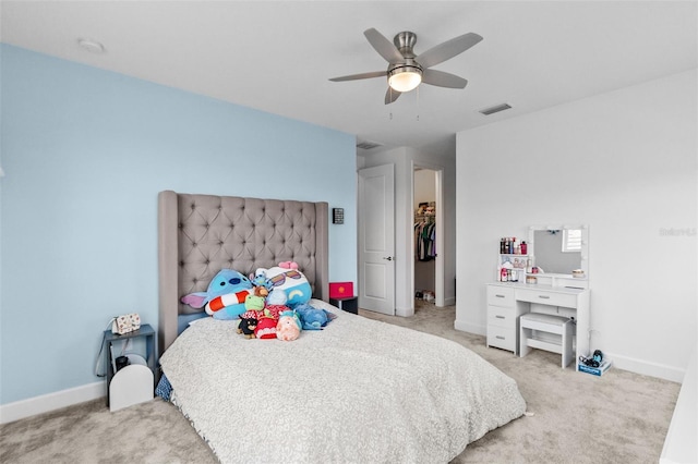 carpeted bedroom with ceiling fan and a closet