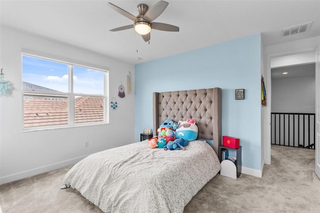 bedroom with ceiling fan and light carpet