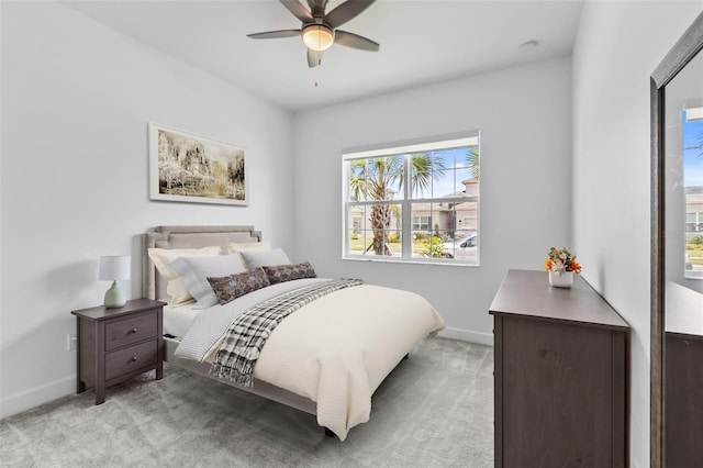 bedroom with ceiling fan and light carpet