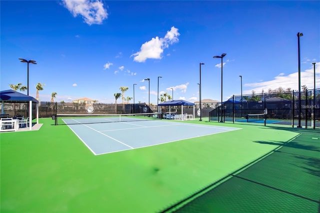 view of tennis court with a gazebo and basketball hoop