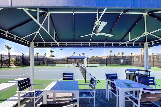 view of patio / terrace with a gazebo, ceiling fan, and tennis court