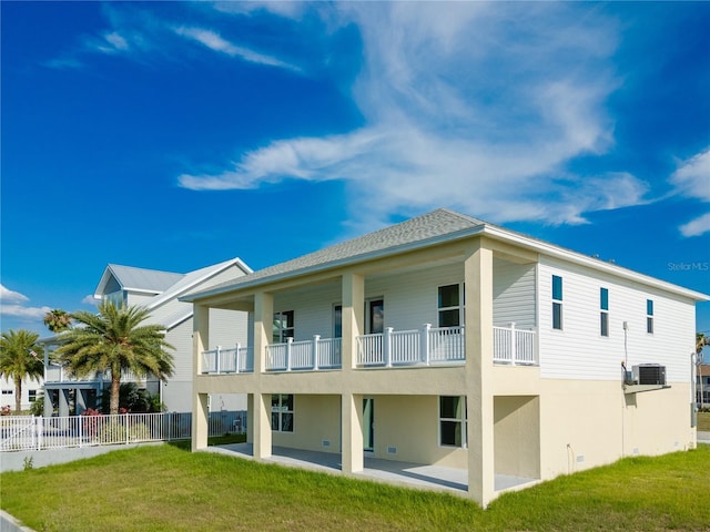 3431 Sheephead Dr, Hernando Beach, FL 34607 - rear view of house with a balcony, a patio area, and stucco siding