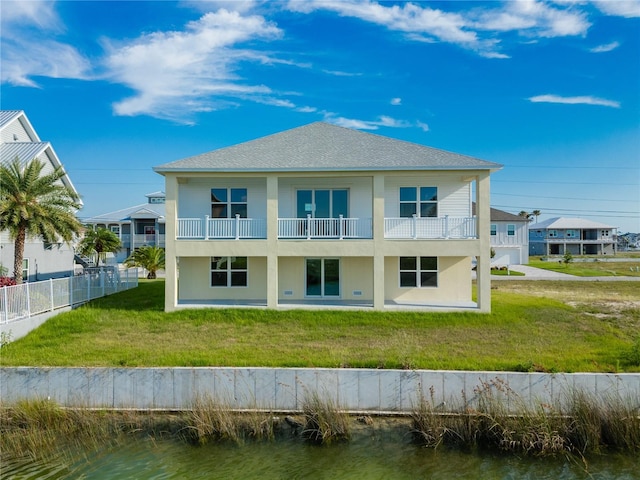 3431 Sheephead Dr, Hernando Beach, FL 34607 - rear view of house with a water view, a balcony, and roof with shingles