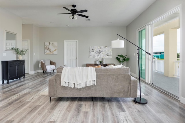 3431 Sheephead Dr, Hernando Beach, FL 34607 - living area with light wood-style floors, ceiling fan, and baseboards