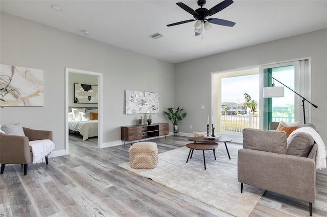 3431 Sheephead Dr, Hernando Beach, FL 34607 - living area with light wood-type flooring, ceiling fan, and baseboards