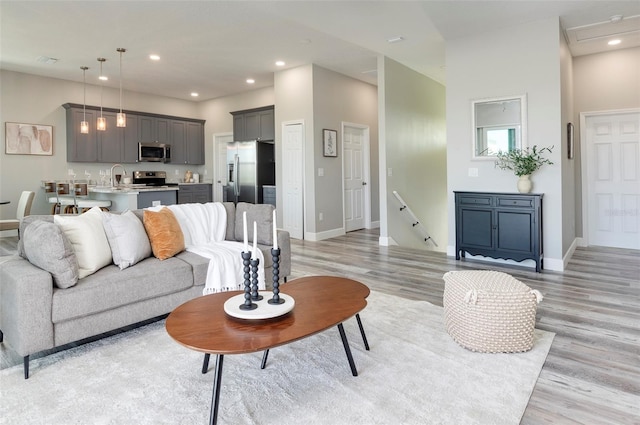 3431 Sheephead Dr, Hernando Beach, FL 34607 - living room featuring light wood-type flooring, baseboards, and recessed lighting