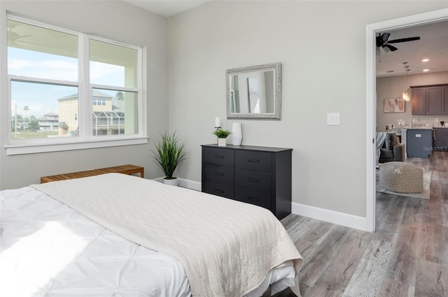 3431 Sheephead Dr, Hernando Beach, FL 34607 - bedroom featuring light wood-style flooring, radiator, and recessed lighting