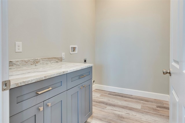 3431 Sheephead Dr, Hernando Beach, FL 34607 - bathroom featuring wood finished floors, baseboards, and vanity