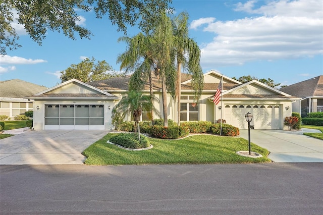 single story home with a garage and a front lawn