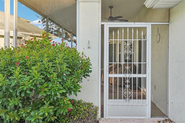 entrance to property featuring ceiling fan