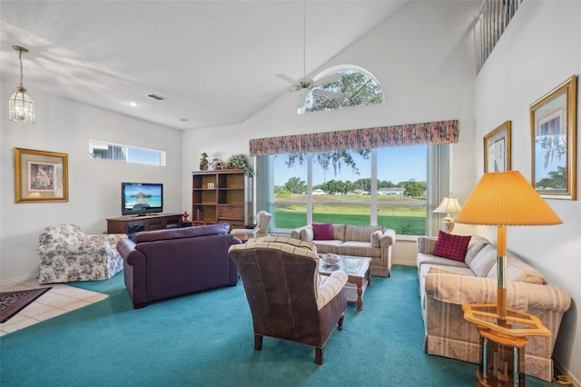 carpeted living room with ceiling fan, a healthy amount of sunlight, and a towering ceiling