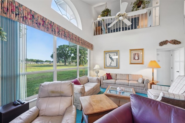 living room featuring ceiling fan and a healthy amount of sunlight