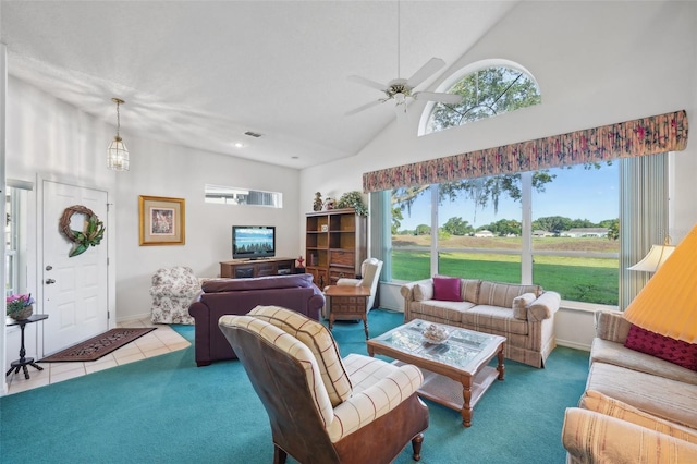 tiled living room featuring ceiling fan and a towering ceiling