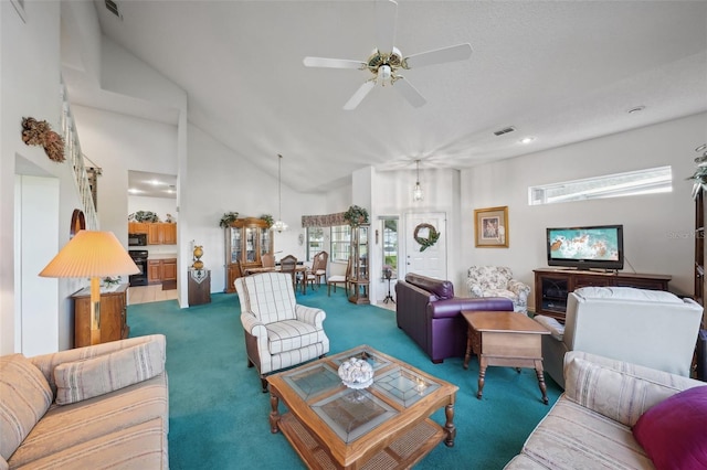 carpeted living room with high vaulted ceiling, ceiling fan, and a wealth of natural light