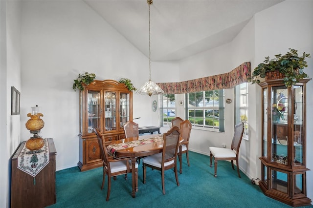 carpeted dining room featuring high vaulted ceiling and a notable chandelier