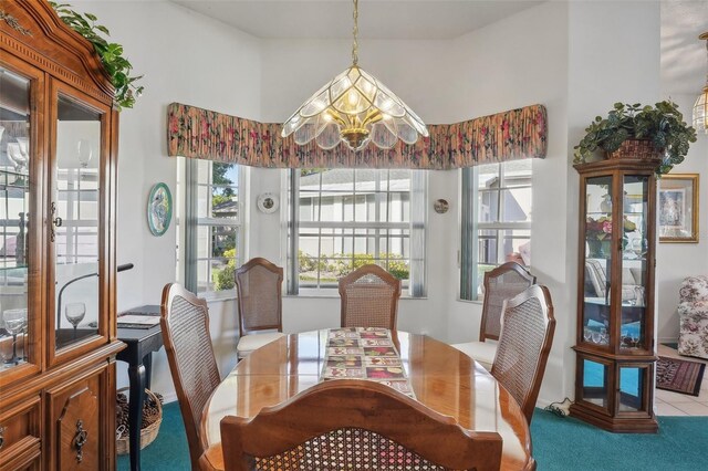 dining room with a notable chandelier and light colored carpet