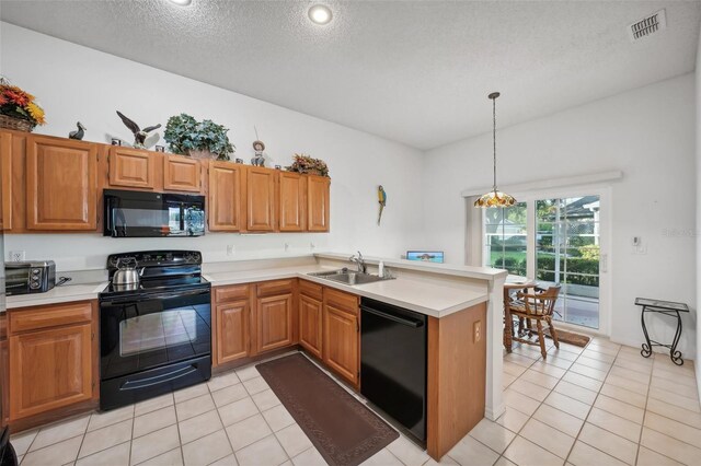 kitchen with sink, light tile patterned floors, black appliances, and a textured ceiling