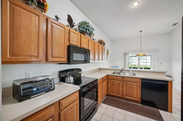 kitchen featuring kitchen peninsula, sink, black appliances, light tile patterned floors, and pendant lighting