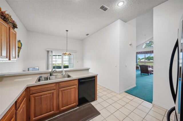 kitchen with dishwasher, sink, hanging light fixtures, a textured ceiling, and light tile patterned flooring