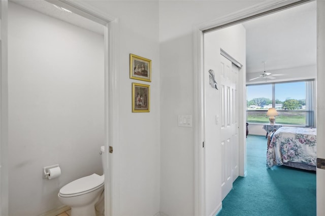 bathroom featuring ceiling fan and toilet