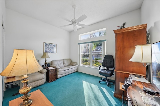 carpeted home office featuring ceiling fan