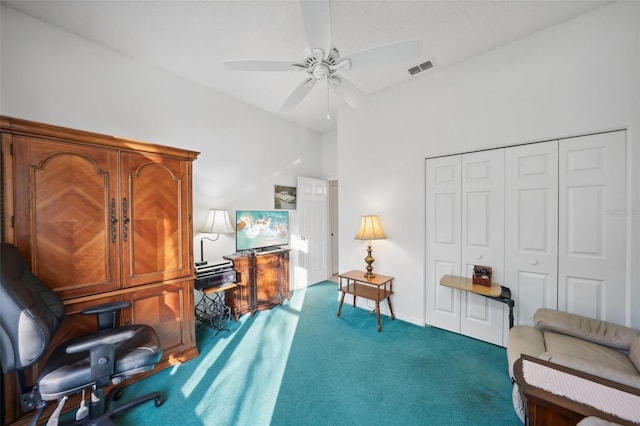 living area featuring ceiling fan, carpet, and vaulted ceiling