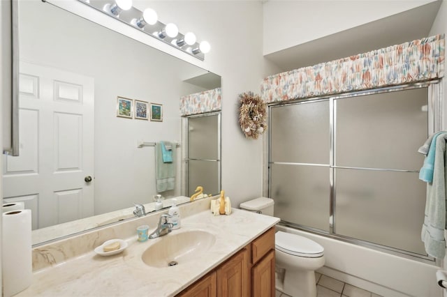 full bathroom with tile patterned flooring, vanity, toilet, and enclosed tub / shower combo