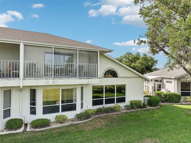 back of property featuring a lawn