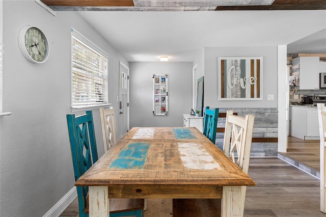 dining area with dark hardwood / wood-style flooring