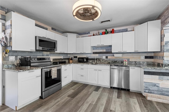 kitchen with white cabinets, stainless steel appliances, and sink