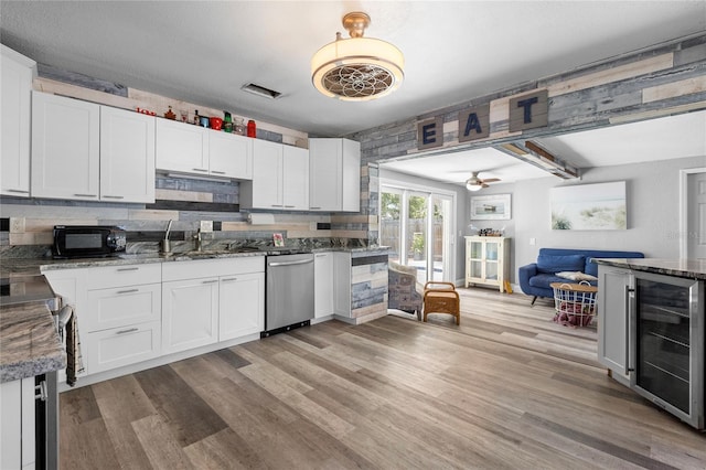 kitchen with white cabinetry, dishwasher, wine cooler, light hardwood / wood-style flooring, and backsplash