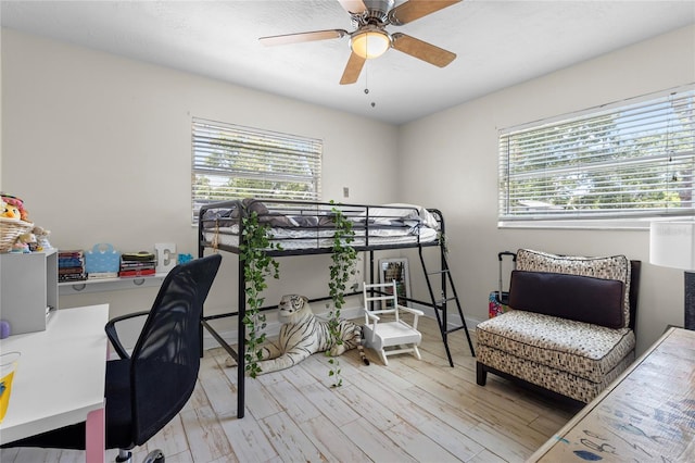 bedroom with ceiling fan and light hardwood / wood-style flooring