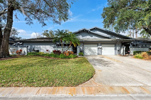 ranch-style home featuring a front lawn and a garage