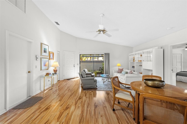 living room featuring light wood-type flooring, ceiling fan, and lofted ceiling