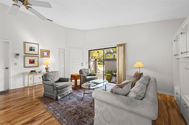 living room featuring hardwood / wood-style floors and ceiling fan