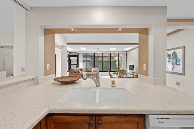 kitchen featuring ceiling fan, dishwasher, and sink