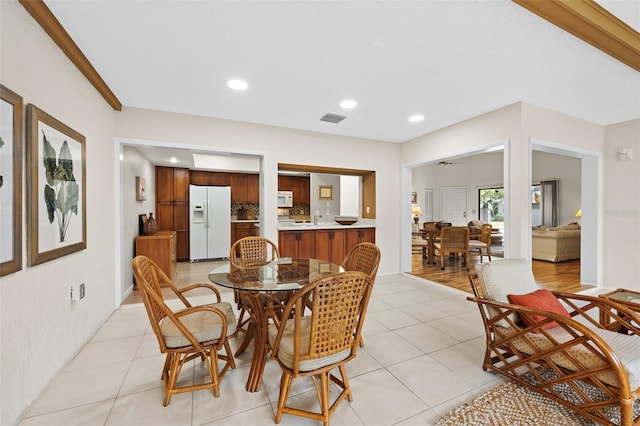 dining area with ceiling fan and light tile patterned floors