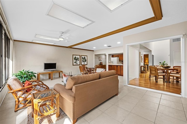 tiled living room featuring ceiling fan