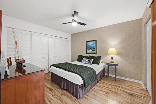 bedroom with ceiling fan, light hardwood / wood-style floors, and a closet