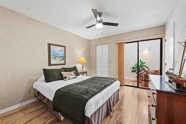 bedroom with ceiling fan, a textured ceiling, and light wood-type flooring