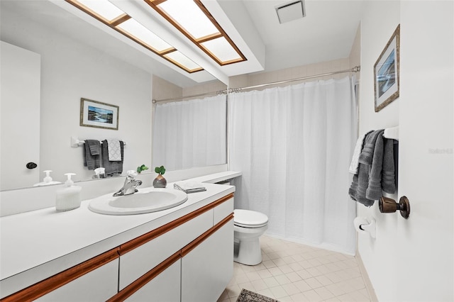 bathroom with tile patterned flooring, vanity, and toilet